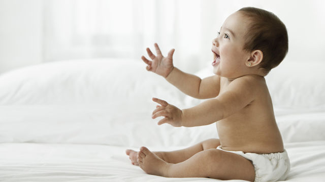 A baby is smiling after natural teething remedies 