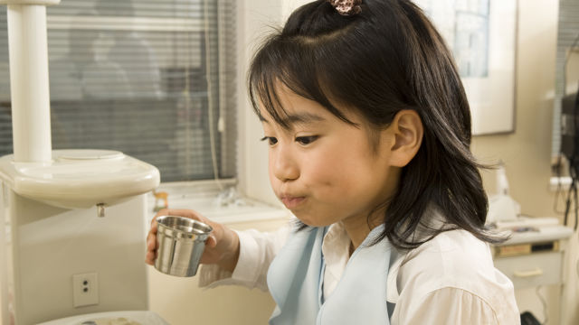 Girl washing her mouth