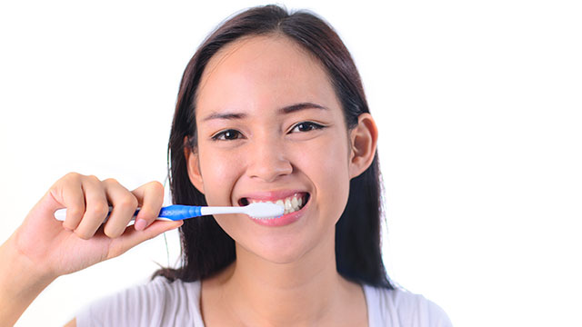 Woman brushing her teeth
